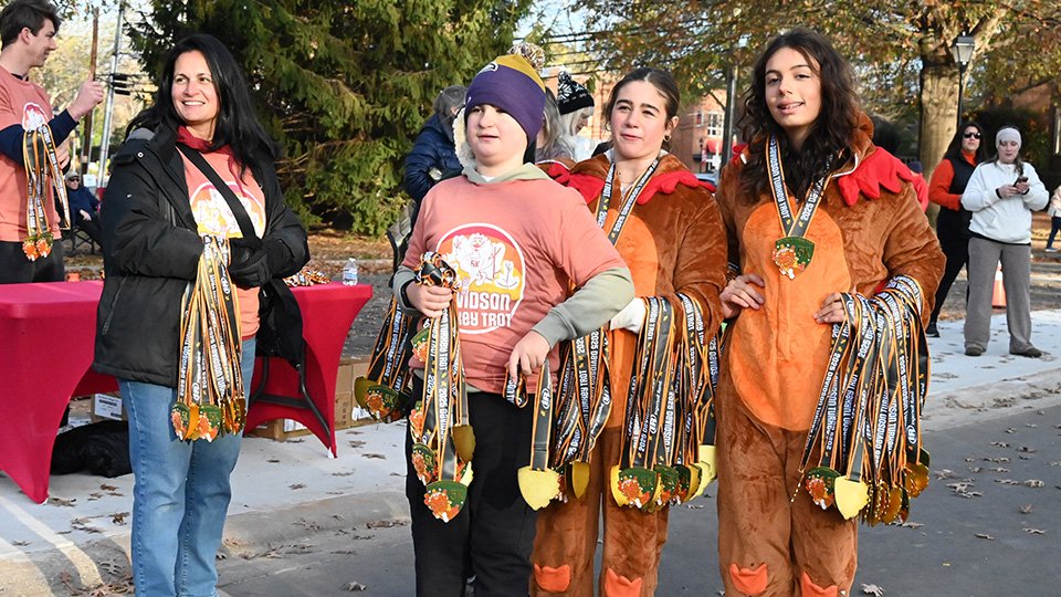 Davidson Turkey Trot Handing Out Finish Medals